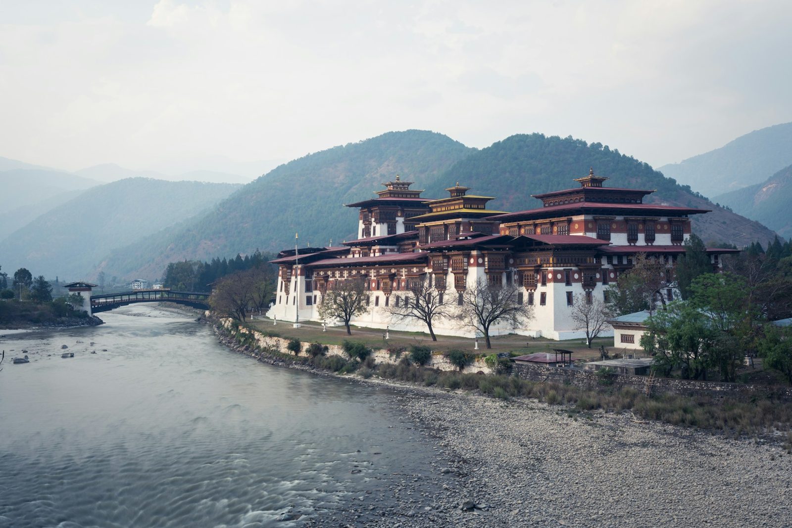 Punakha Dzong at the meeting of two rivers with mountains behind